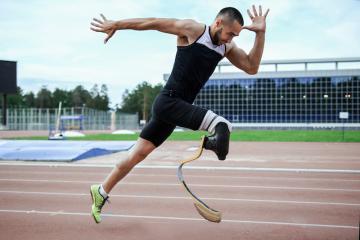 Athlete sprinting with prosthetics sprinting leg